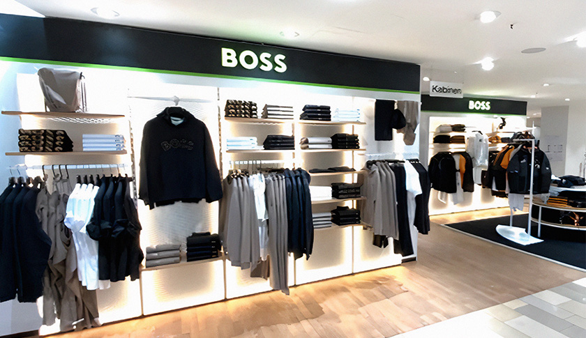 The inside of a Hugo Boss store with display shelves with male’s clothing (photo)